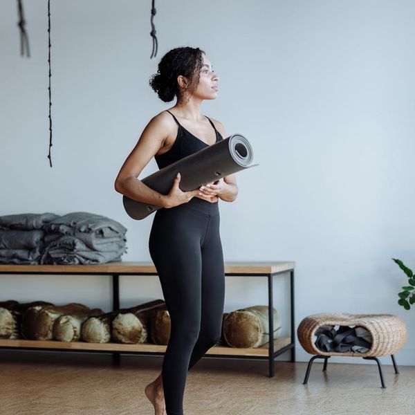 A person maintaining a difficult balance yoga pose indoors.